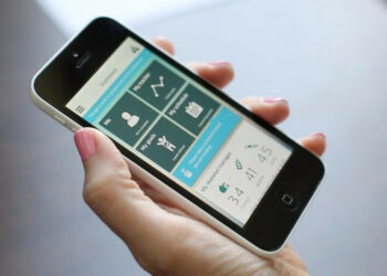 A hand with a smartphone with a medical app on the screen